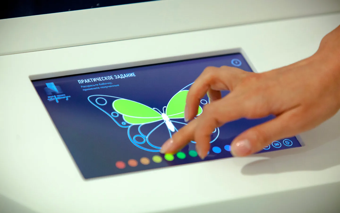 Visitor using the color mixing interface on a touchscreen.
